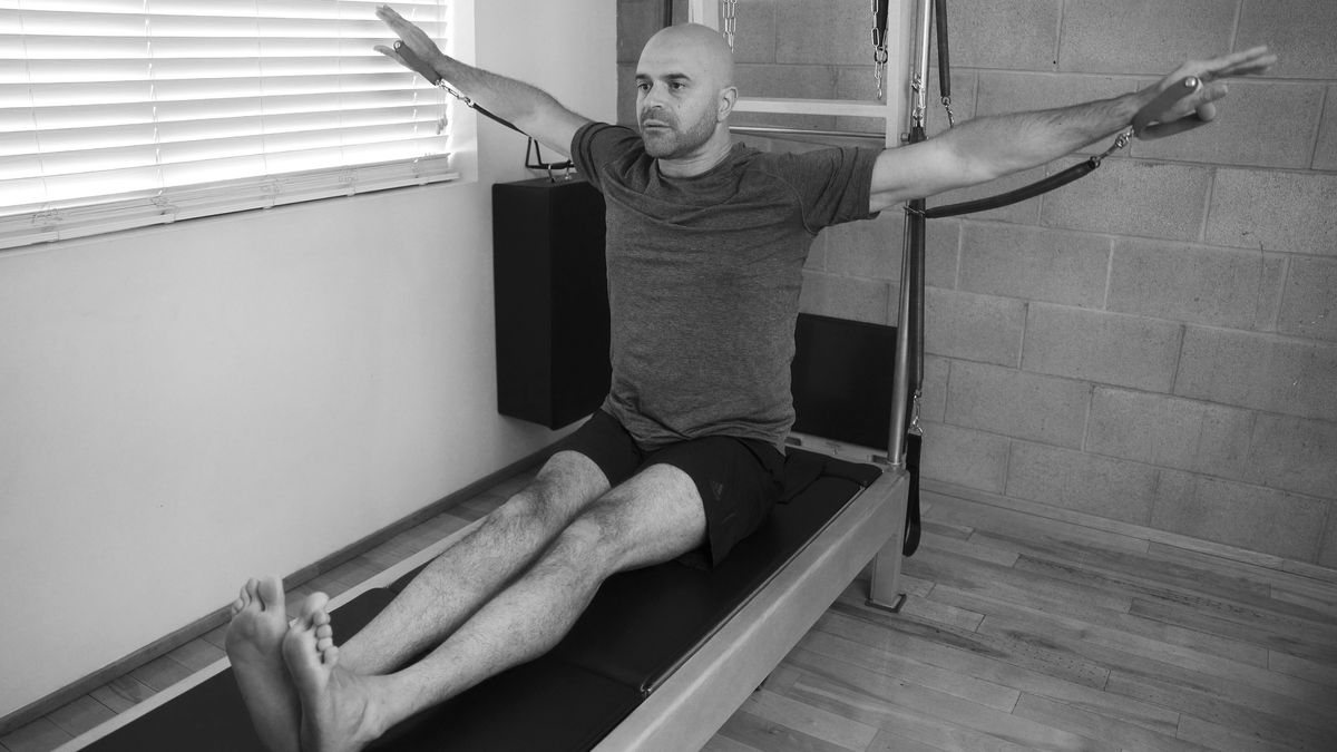 "Best Pilates West Hollywood offers, captured in an image of a dedicated man practicing on a Contrology tower at our LA Pilates Studio."
