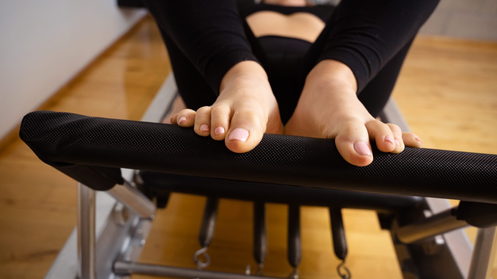 Feet pressing the pedal of the wunda chair at West Hollywood Pilates